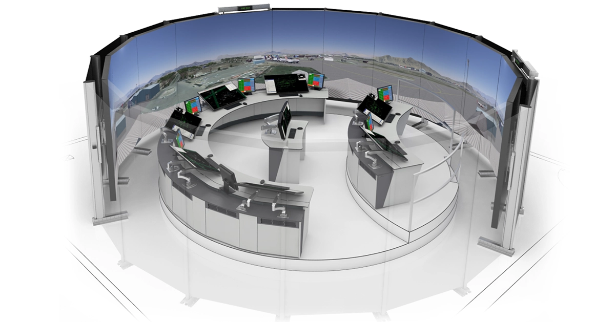 A modern air traffic control centre features Air Traffic Training & Simulation Control Room Consoles by LundHalsey, arranged in a circular layout with multiple monitors and curved screens displaying the airport runway and landscape.
