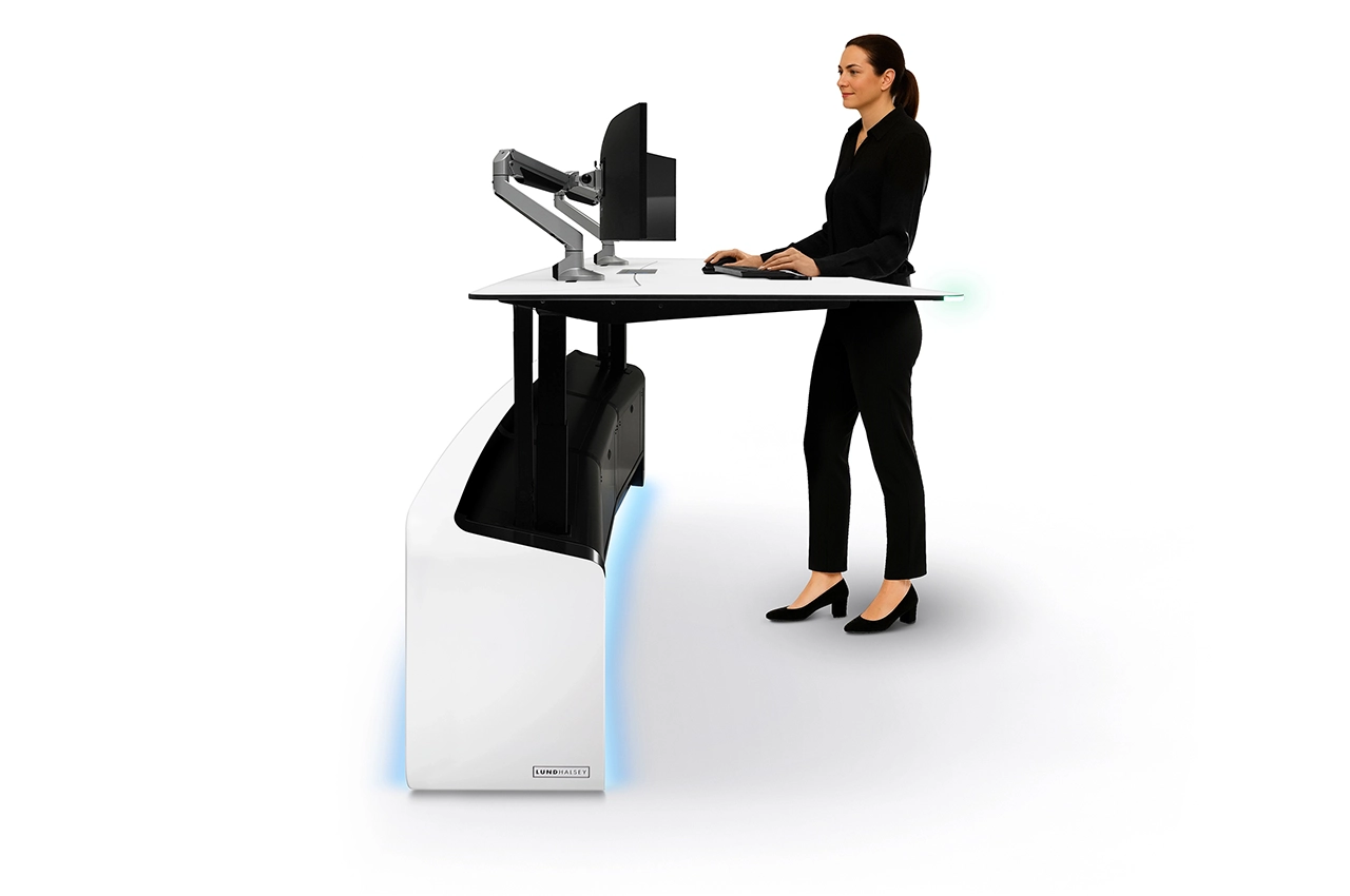 LundHalsey-Optima-Sit-Stand-Operator-Standing.webp Operator standing at raised LundHalsey OPTIMA sit-stand control room console